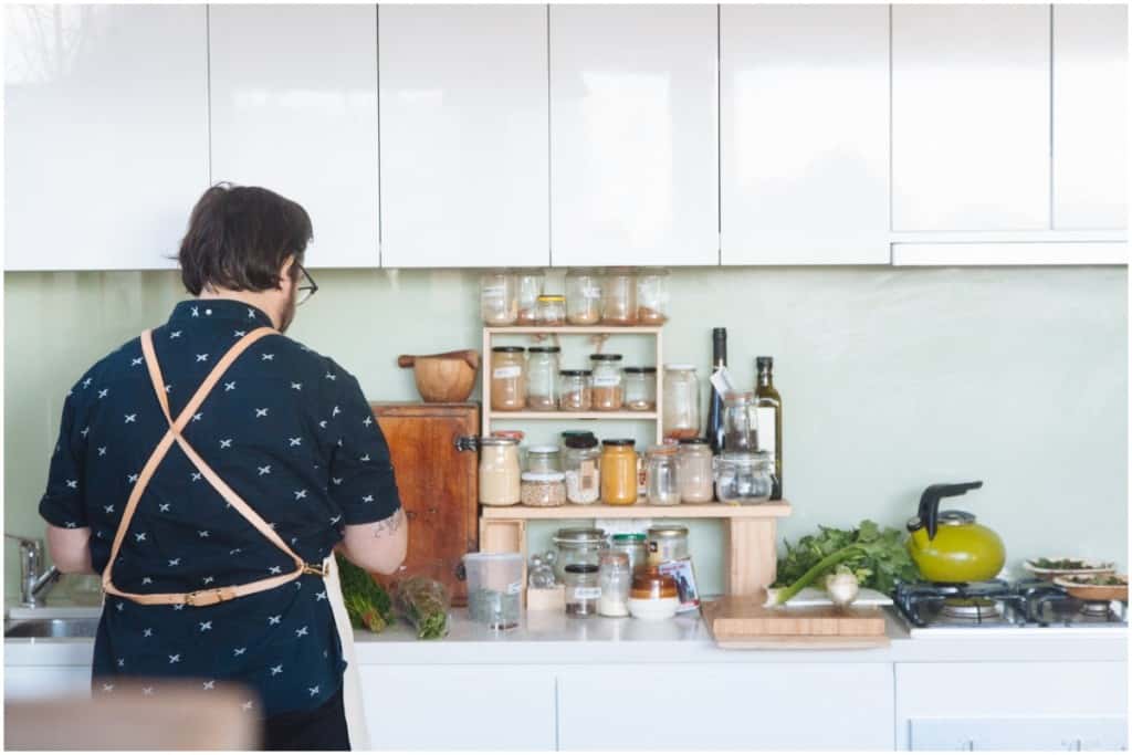 man cooking meal in kitchen self-care sanctuary