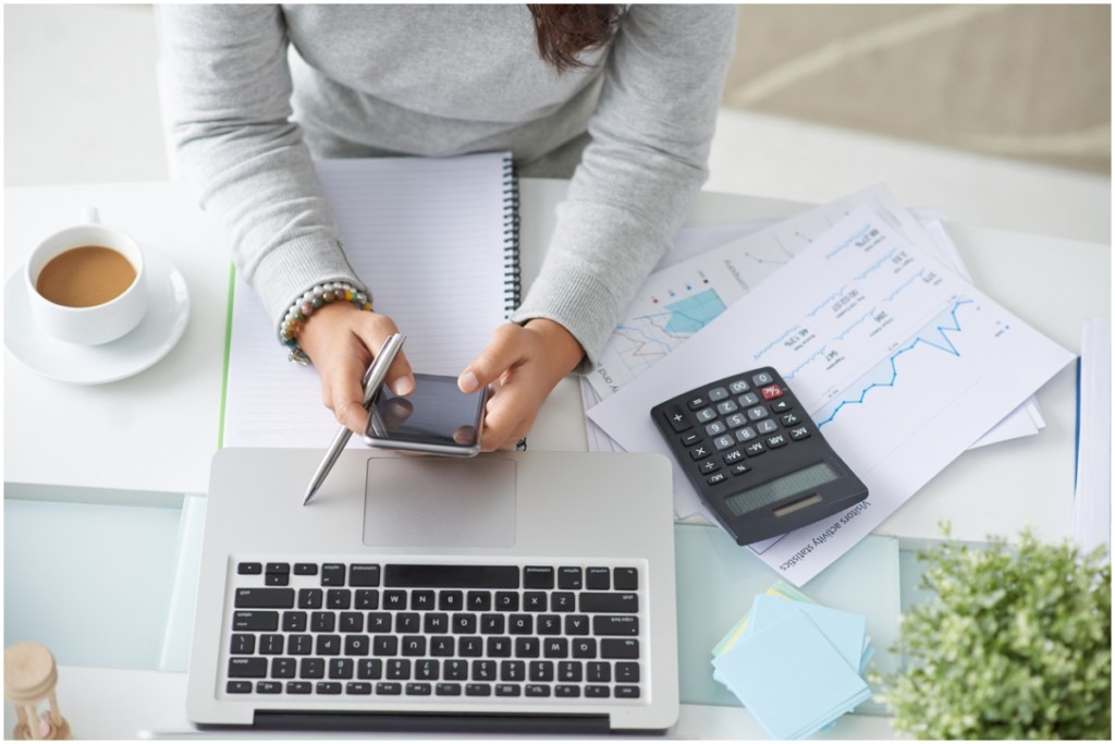 woman doing calculations for how to increase your credit score quickly